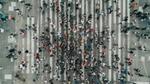 Aeriel view of crowds of people walking across a pedestrian crossing