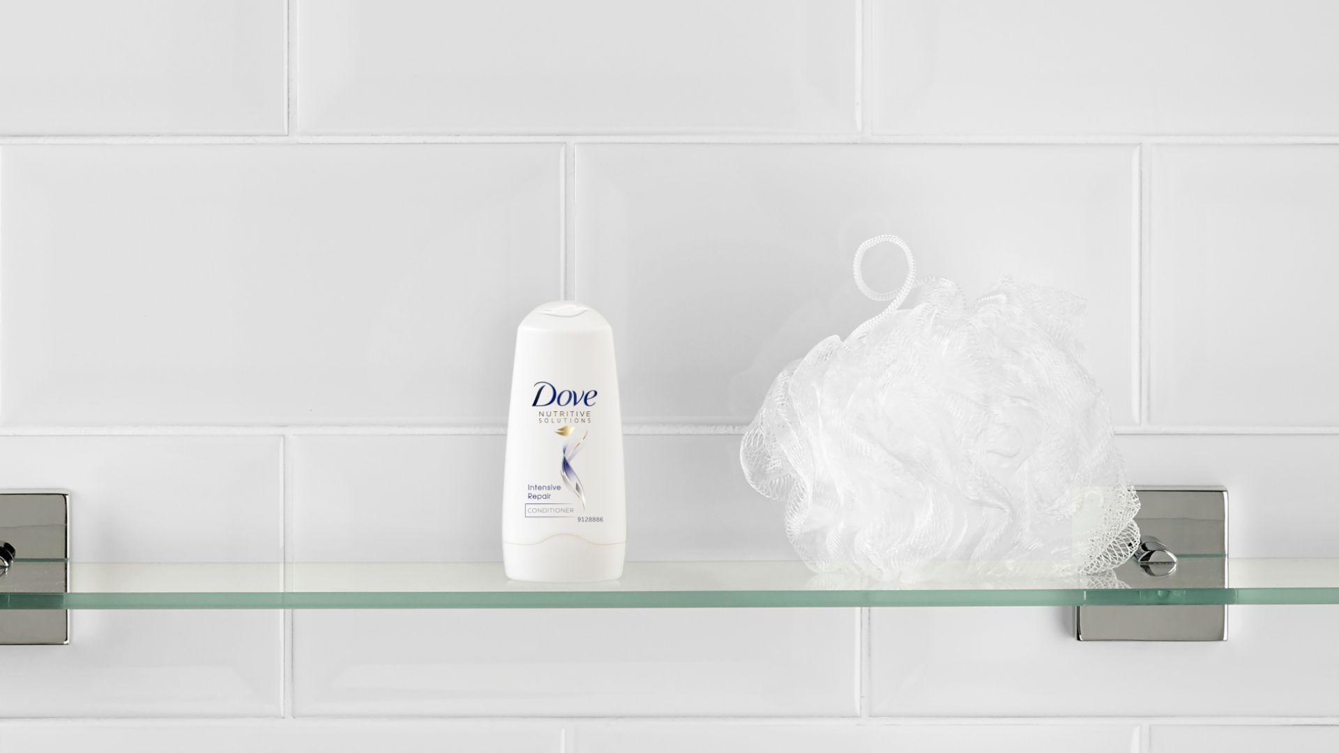 Baby Dove products on a bathroom shelf with a blue soft rabbit toy next to them