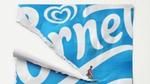 A campaign image of a surfer riding a Cornetto wrapper.