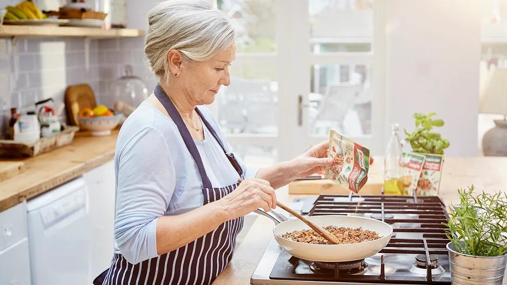 A woman using Knorr products in the kitchen