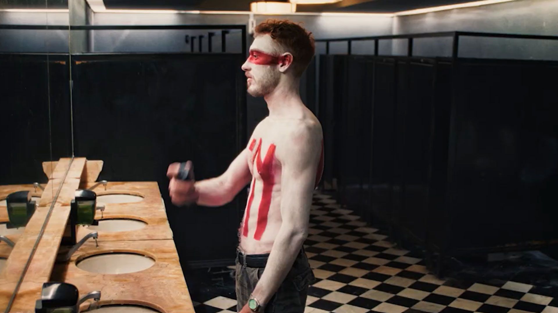 An person spraying deodorant on their body.