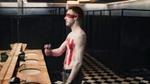 An person spraying deodorant on their body.