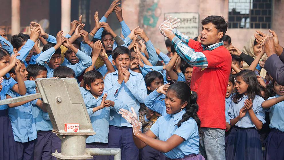 A group of schoolchildren washing their hands
