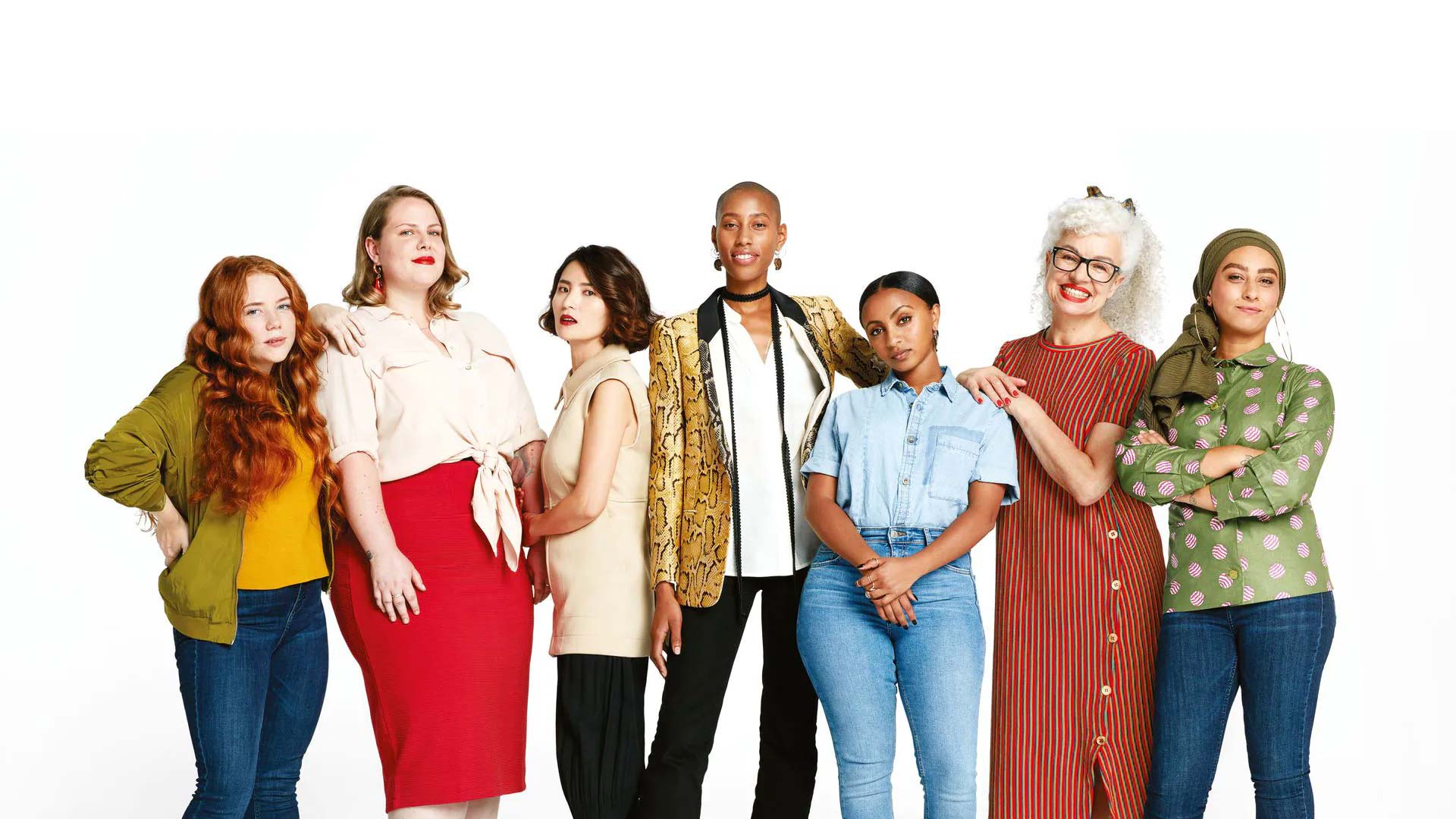 Seven women standing together side by side.