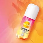 A Sunsilk Wondermist product bottle placed on a vibrant pink‑to‑orange gradient background with a soft, floral pattern.
