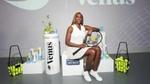 Tennis player Venus Williams at a Dove Keep her Confident launch event. Venus is sitting, holding a tennis racket and smiling at the camera.