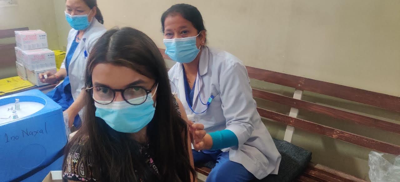 Young woman being vaccinated
