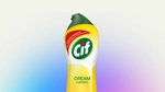 Bottle of Cif Lemon cleaning cream against a soft blue and purple background
