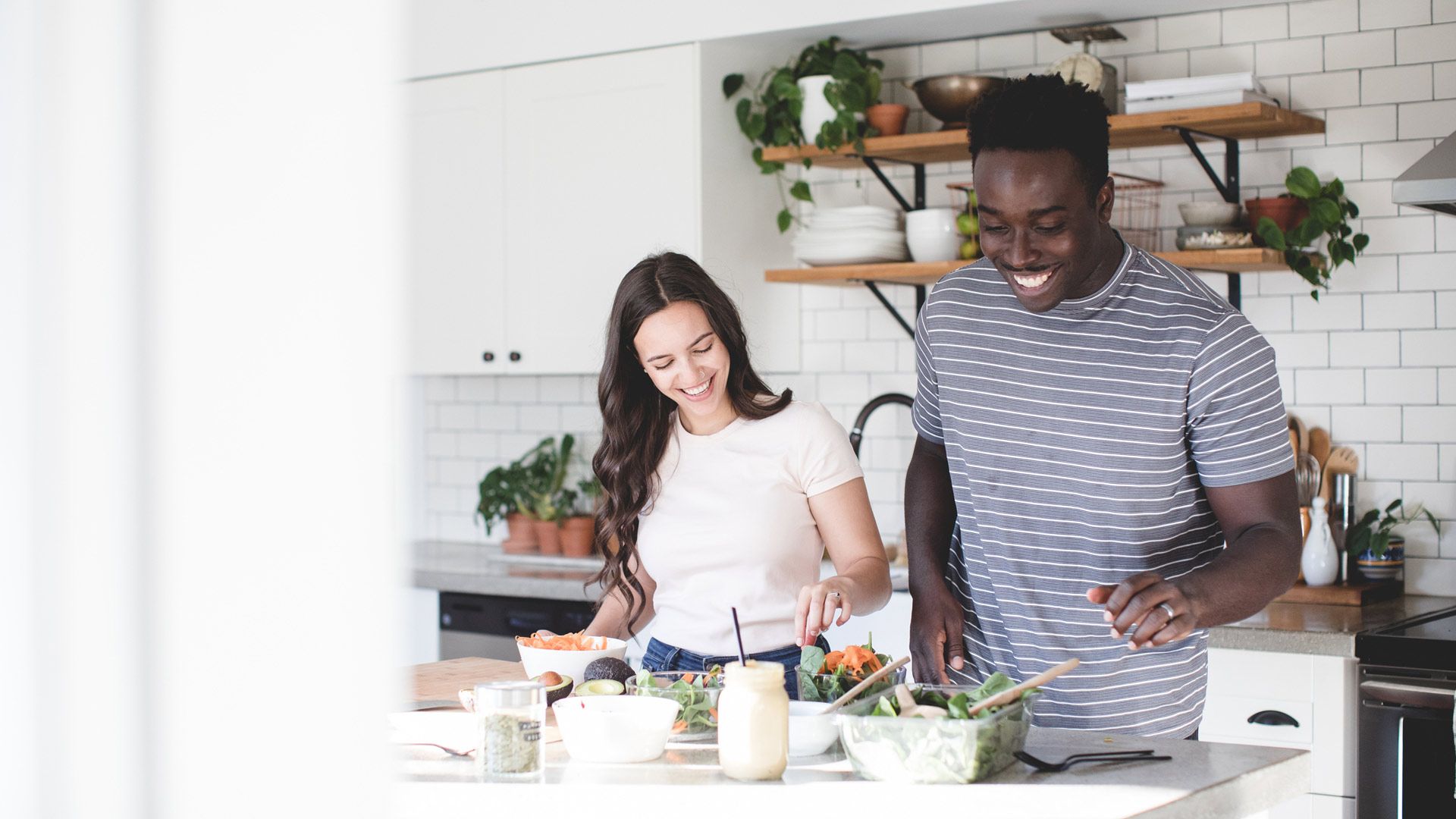 Two people cooking together cheerfully