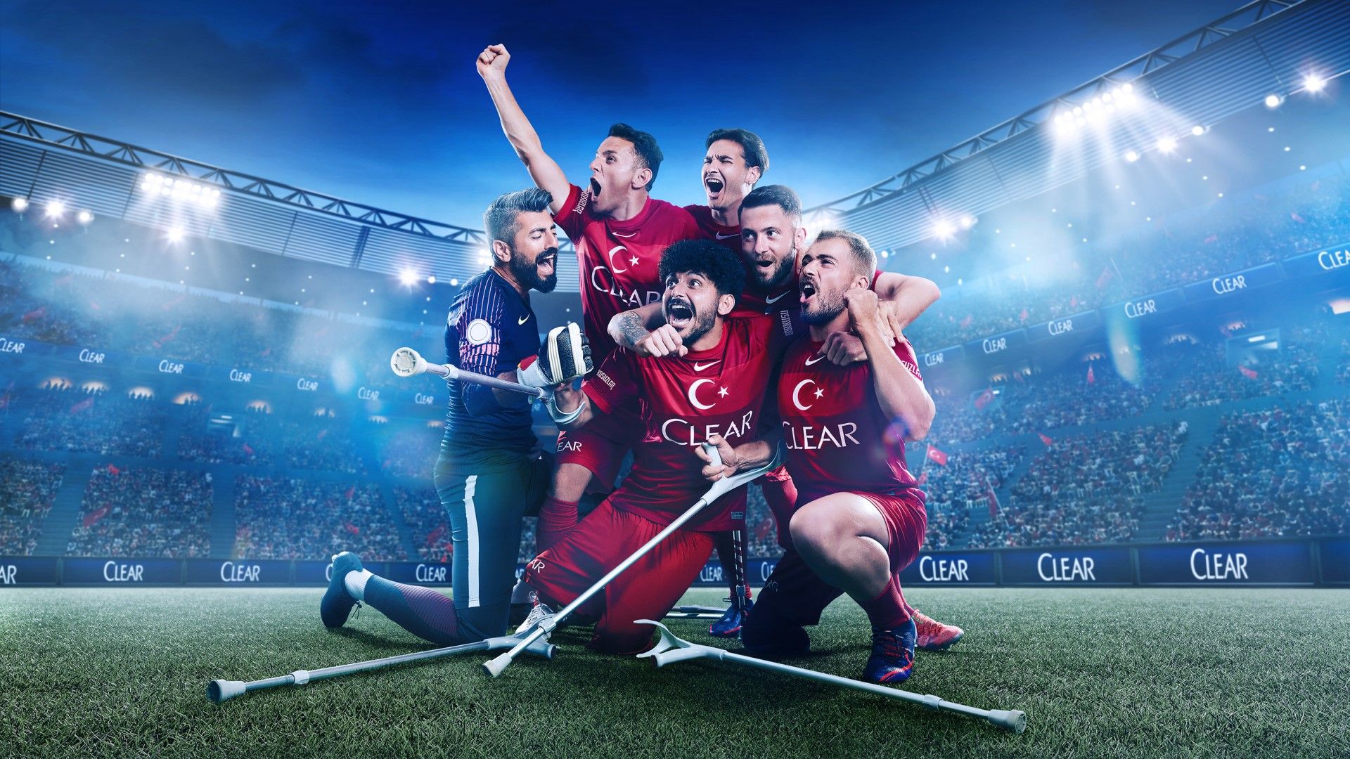 Footballers celebrating. Some are using crutches. Their shirts feature the logo of Unilever’s Clear anti-dandruff shampoo