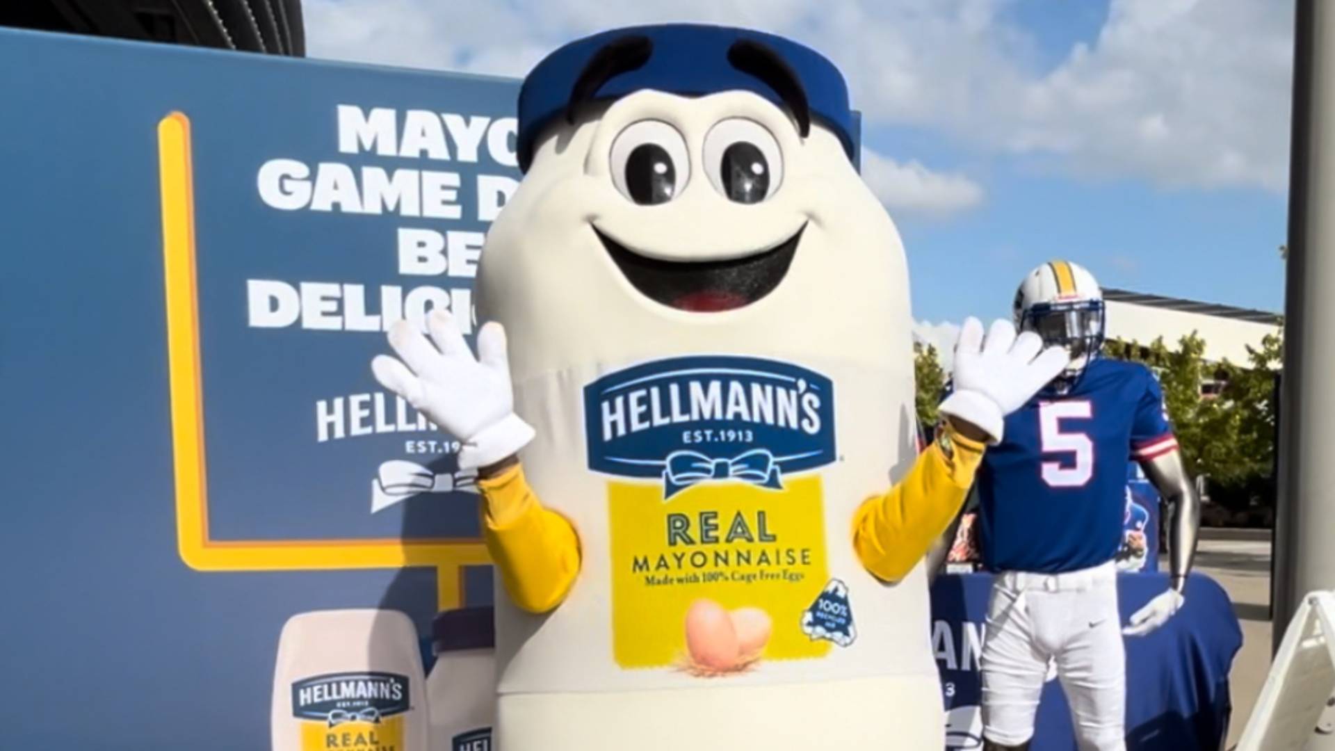 Manny Mayo, a football mascot designed to resemble a jar of Hellmann’s mayonnaise. He has yellow legs and blue shoes.