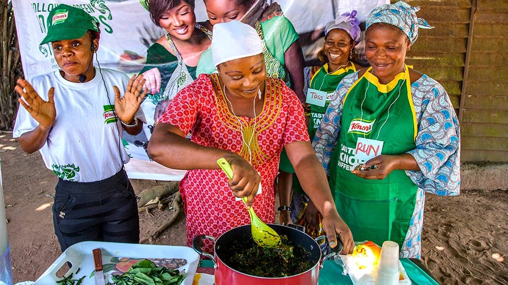 A group of women cooking outside