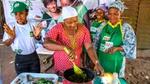 A group of women cooking outside