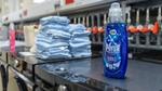 Bottles of Persil Wonder Wash and a stack of towels on top of washing machines in Unilever’s laundry detergent testing lab.