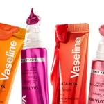 Four brightly coloured tubes of Vaseline Gluta Hya lip serum with product dripping from the tubes set on a white background.