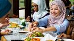 Ladies sitting at a table, eating and sharing food