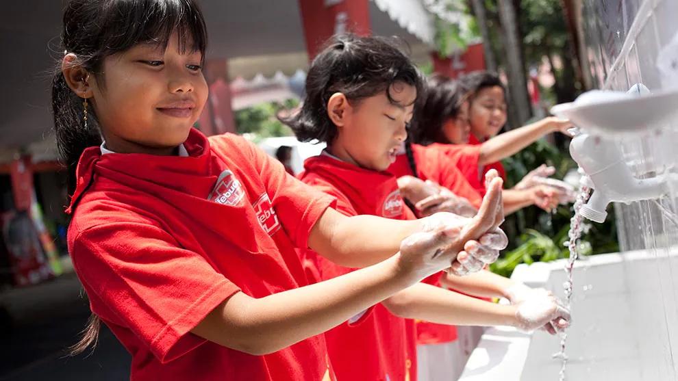 Young girls washing their hands