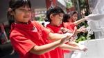 Young girls washing their hands