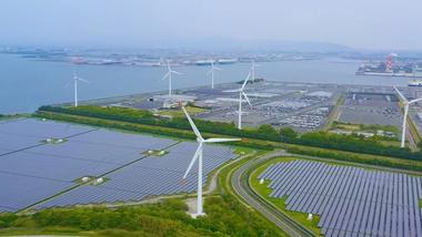 Landscape including wind turbines and solar panels