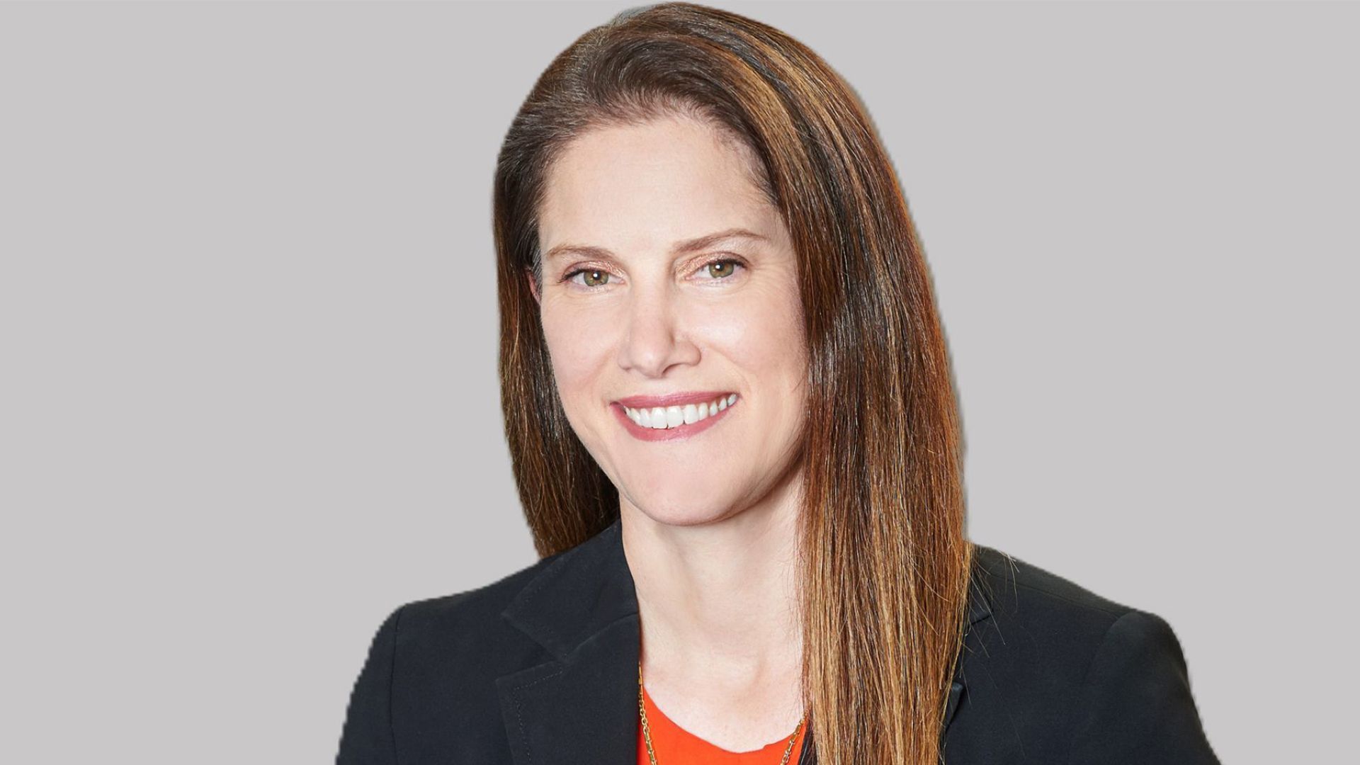 Profile picture of Zoe Yujnovich wearing a red top with a dark jacket.