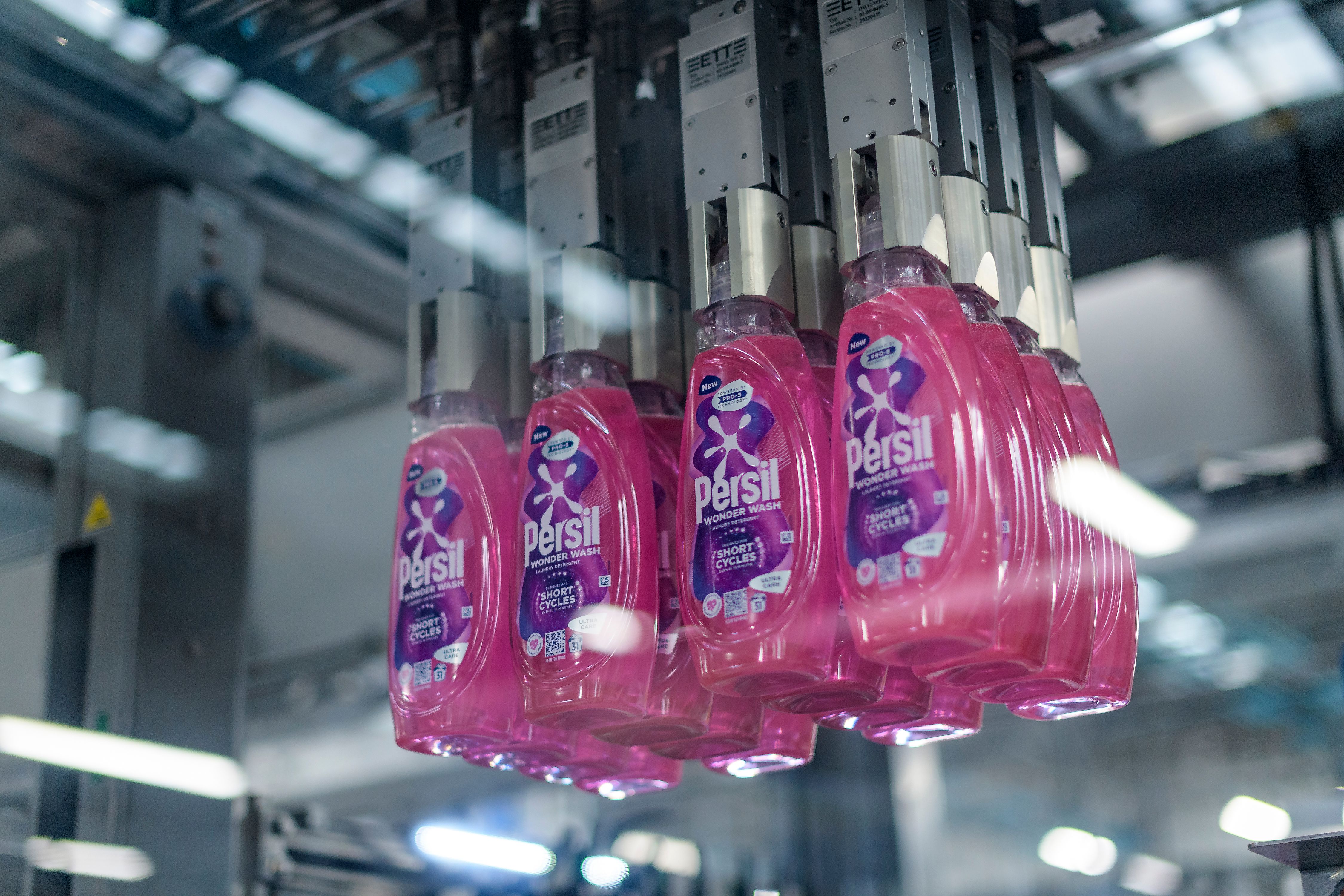 Bottles of Persil Wonder Wash on a factory production line.