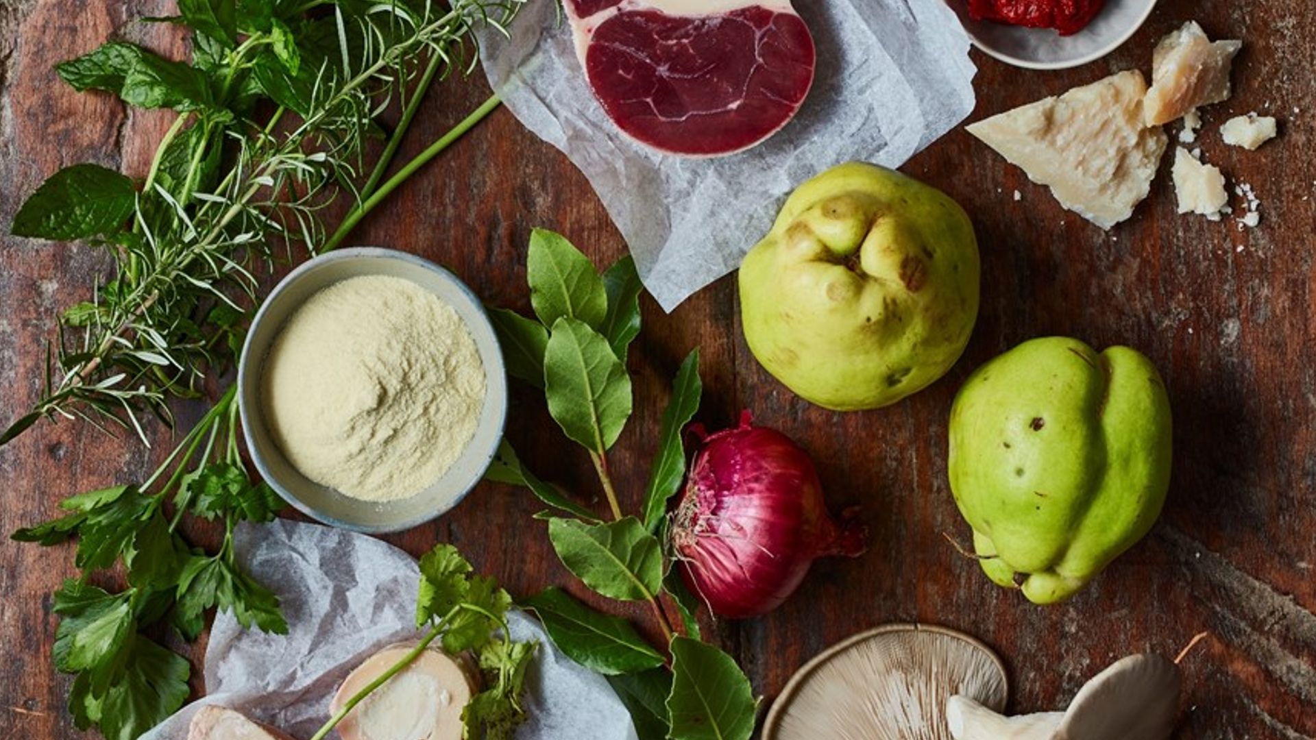 A selection of herbs and foods including red meat, bay leaves and hummus 