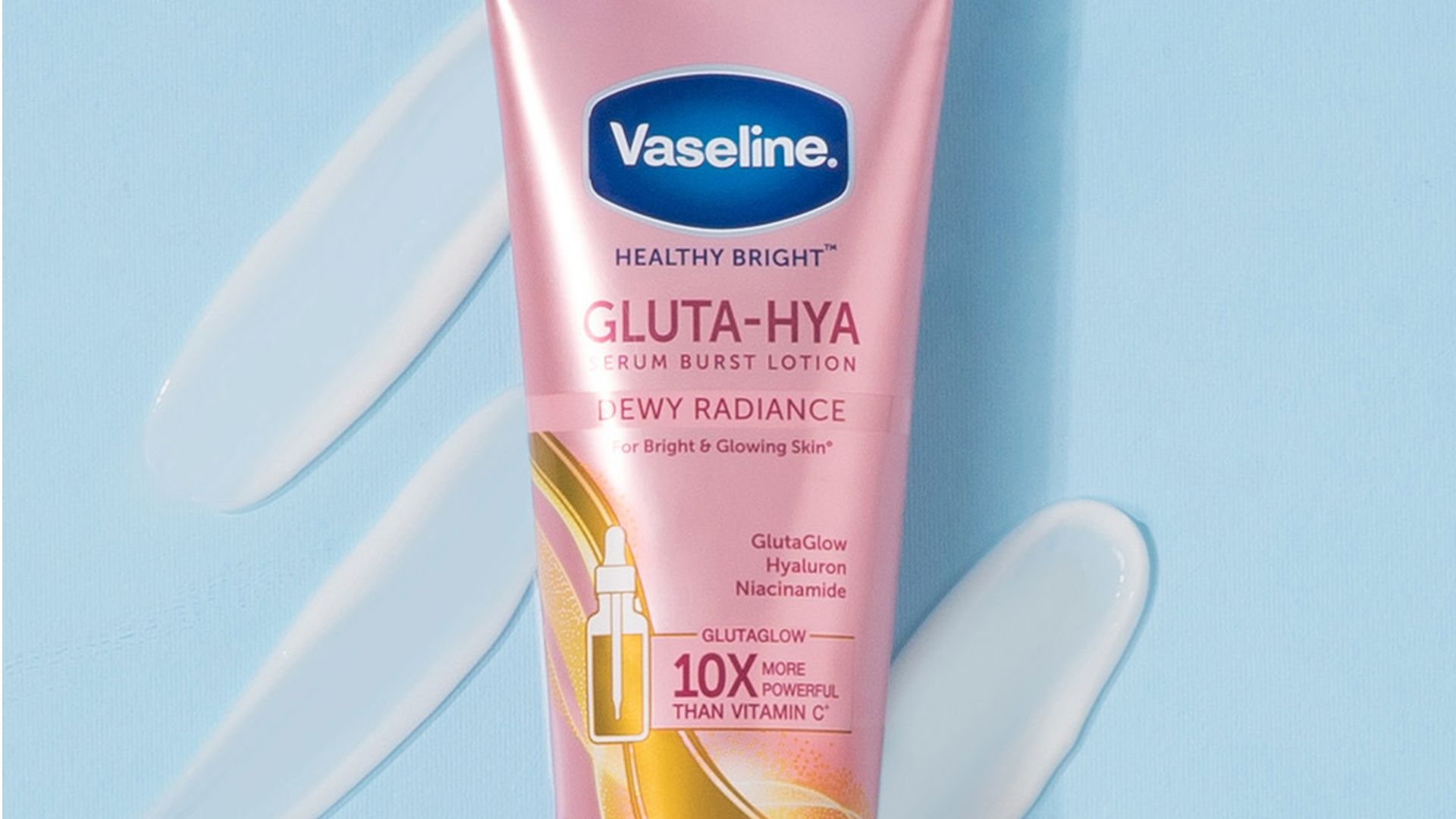 A pink tube of Vaseline “Gluta-Hya” cream against a light blue background.