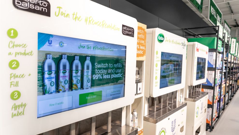 Three refill machines for Unilever brands lined up in the aisle of the Asda store in Leeds, UK.