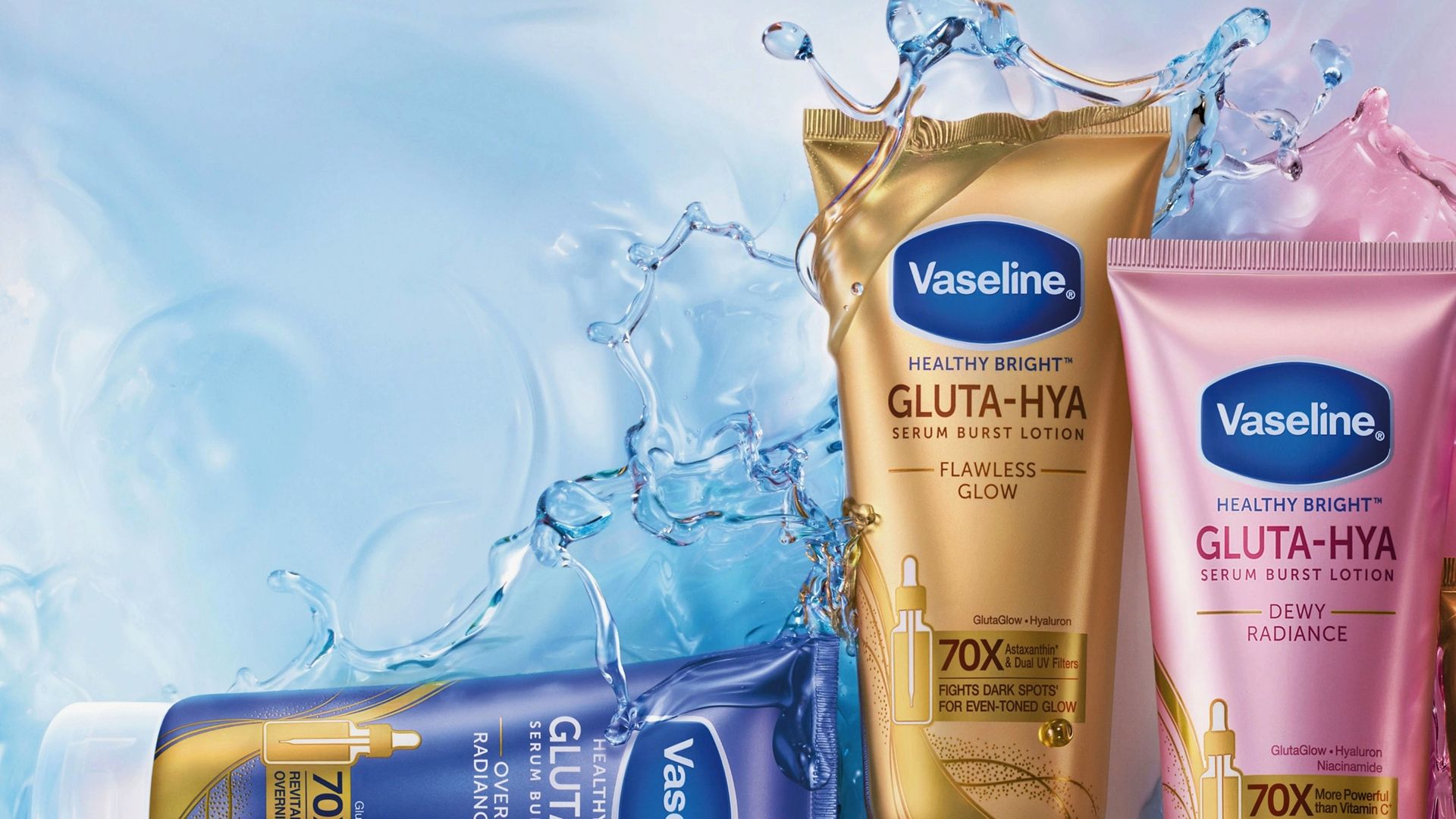 Three Vaseline Healthy Bright Gluta-Hya serum burst lotion tubes in gold, pink, and purple displayed against a water splash background.