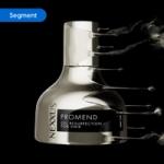 Nexxus Promend Oil Resurrection for Hair bottle in metallic silver with dynamic liquid splash effect on a black background. The image is tagged ‘Segment’.