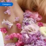 Close-up of an underarm adorned with pink and purple flower petals, creating a floral decorative effect. The image is tagged ‘Category’.