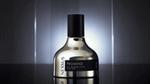 Nexxus Promend Oil Resurrection for Hair bottle with a sleek metallic finish and black cap, set against a dark reflective background with vertical light streaks and a soft glow.