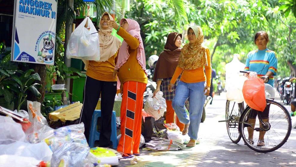 People holding bags of plastic