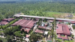 An aerial photo of Unilever’s Tinsukia factory in India, recognised by the World Economic Forum’s Lighthouse Network. The large rural building has a sustainable water collection pool and solar panels.