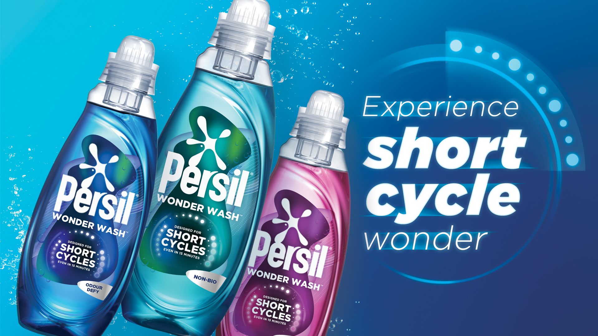 Three bottles of Persil Wonder Wash all of different variants - Odour Defy (blue), Non-Bio (green) and Ultra Care (pink). The label of each bottle states they are ‘Designed for short cycles - even in 15 minutes’. A tagline reads 'Experience short cycle wonder'.