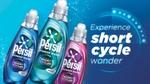 Three bottles of Persil Wonder Wash all of different variants - Odour Defy (blue), Non-Bio (green) and Ultra Care (pink). The label of each bottle states they are ‘Designed for short cycles - even in 15 minutes’. A tagline reads 'Experience short cycle wonder'.