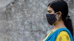 Side Face of an Indian woman wearing homemade cotton nose mask to reduce the spread of Covid-19 – stock photo