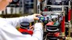 A close-up of a factory team member working on a Knorr production line