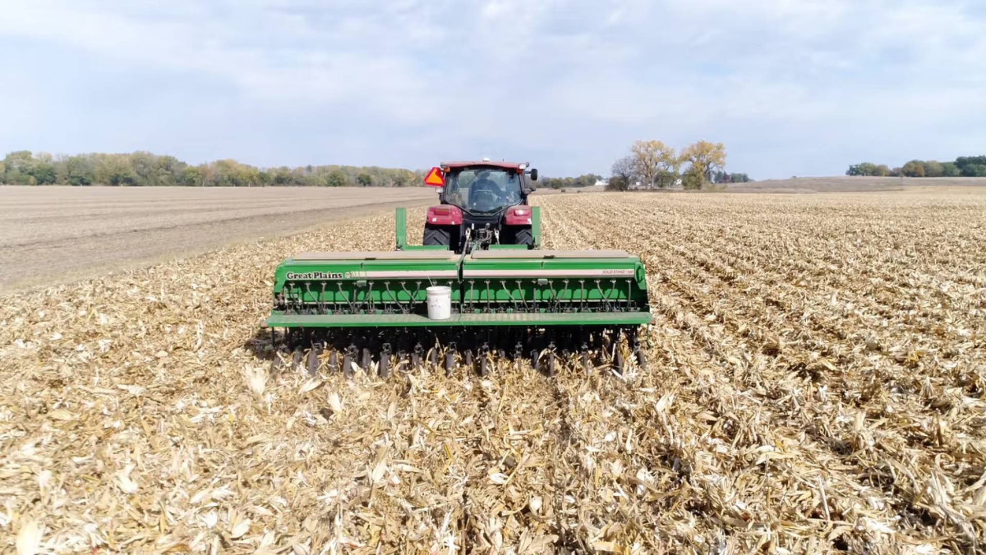 A farmer on a tractor managing crops