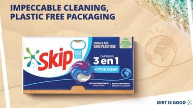 A box of Skip 3-in-1 laundry capsules on a beach with text that reads impeccable cleaning, plastic free packaging.