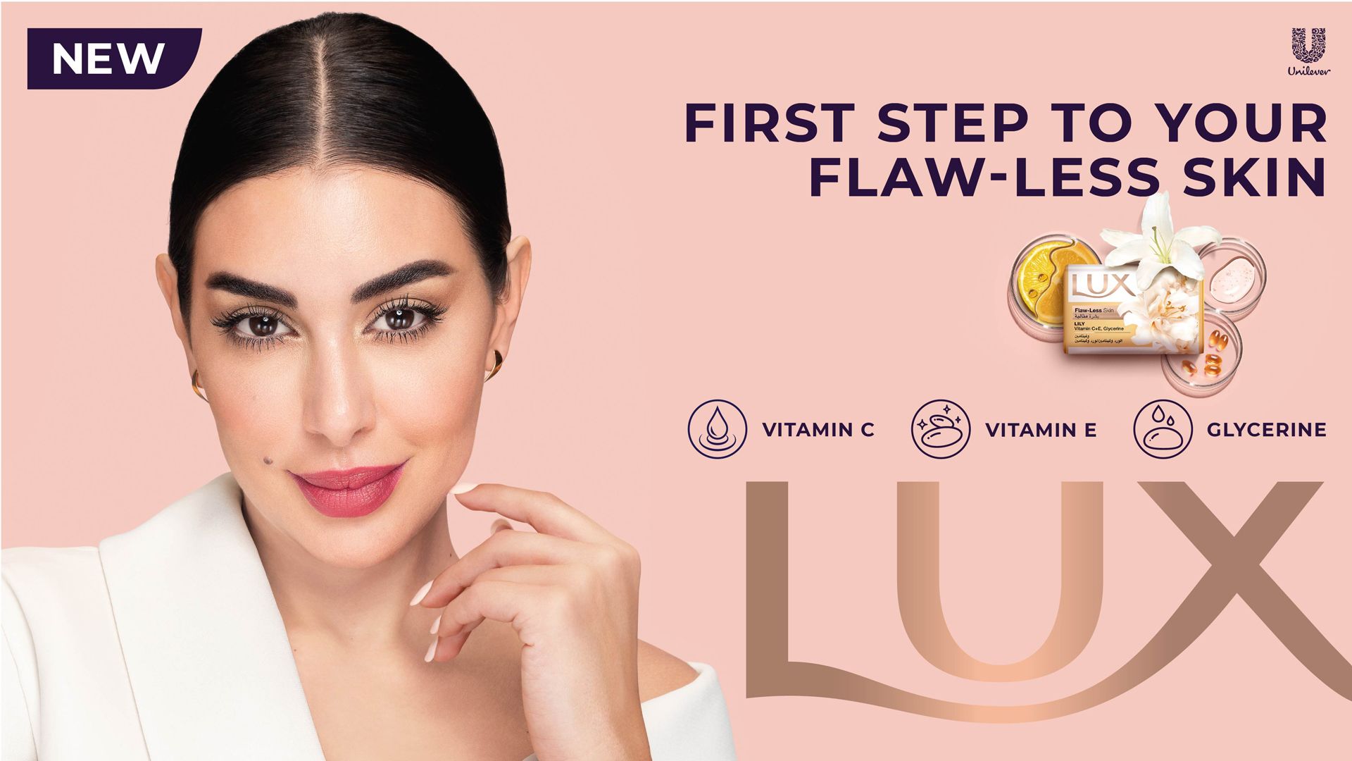 Promotional advertisement for Lux soap featuring Yasmine Sabri, a celebrity and the current face of LUX in Arabia. The image includes the tagline 'FIRST STEP TO YOUR FLAW-LESS SKIN', icons for Vitamin C, Vitamin E, and Glycerine, a Lux soap bar surrounded by flowers and ingredients, a 'NEW' label, and the Unilever logo."