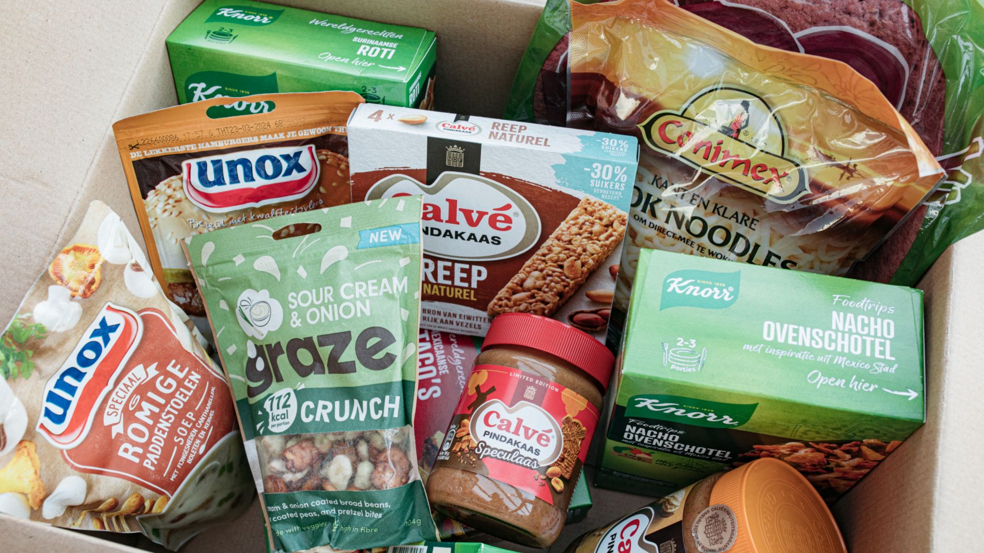 A cardboard box containing Unilever brands including Knorr, Conimex, Calvé and Unox.