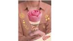 Woman holding the distinctive pink rose-shaped Cornetto Rose cone