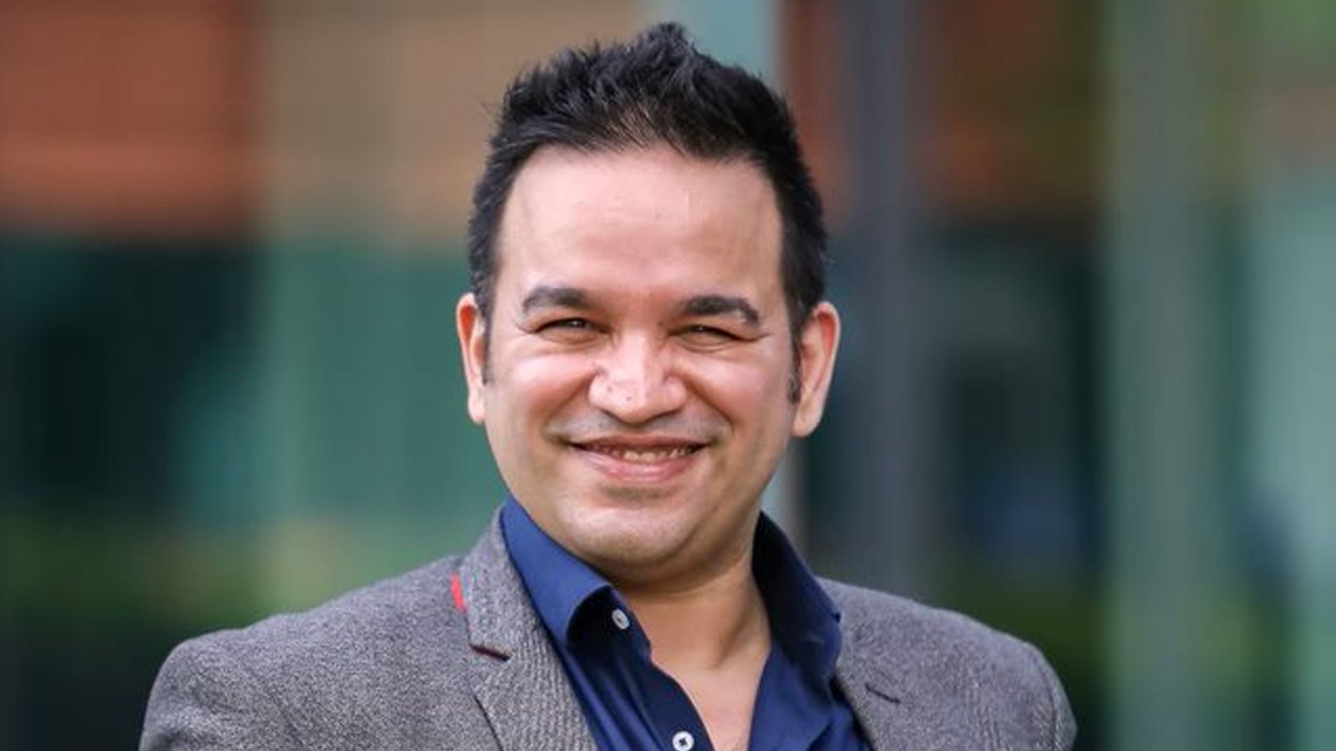 Aseem Puri, CEO of Unilever International, smiling at the camera; UI caters to underserved markets, channels and consumers.