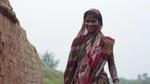 A smiling lady in traditional dress in India.