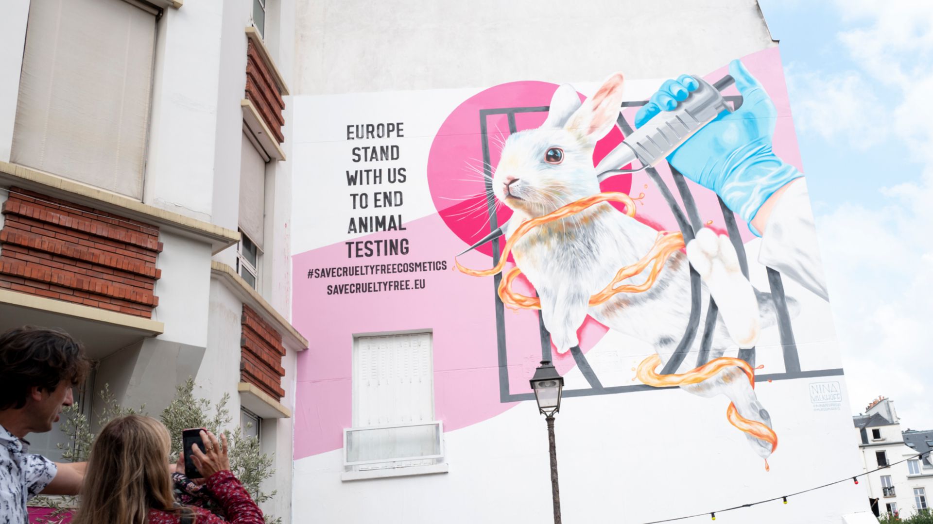 A mural of a white rabbit and a gloved hand holding a syringe. Text reads ‘Europe: stand with us to end animal testing'