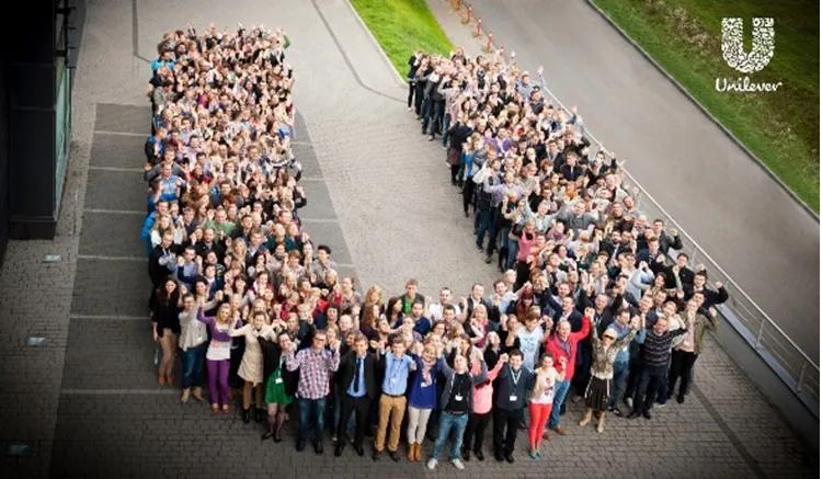 A group of Unilever employees forming the letter U