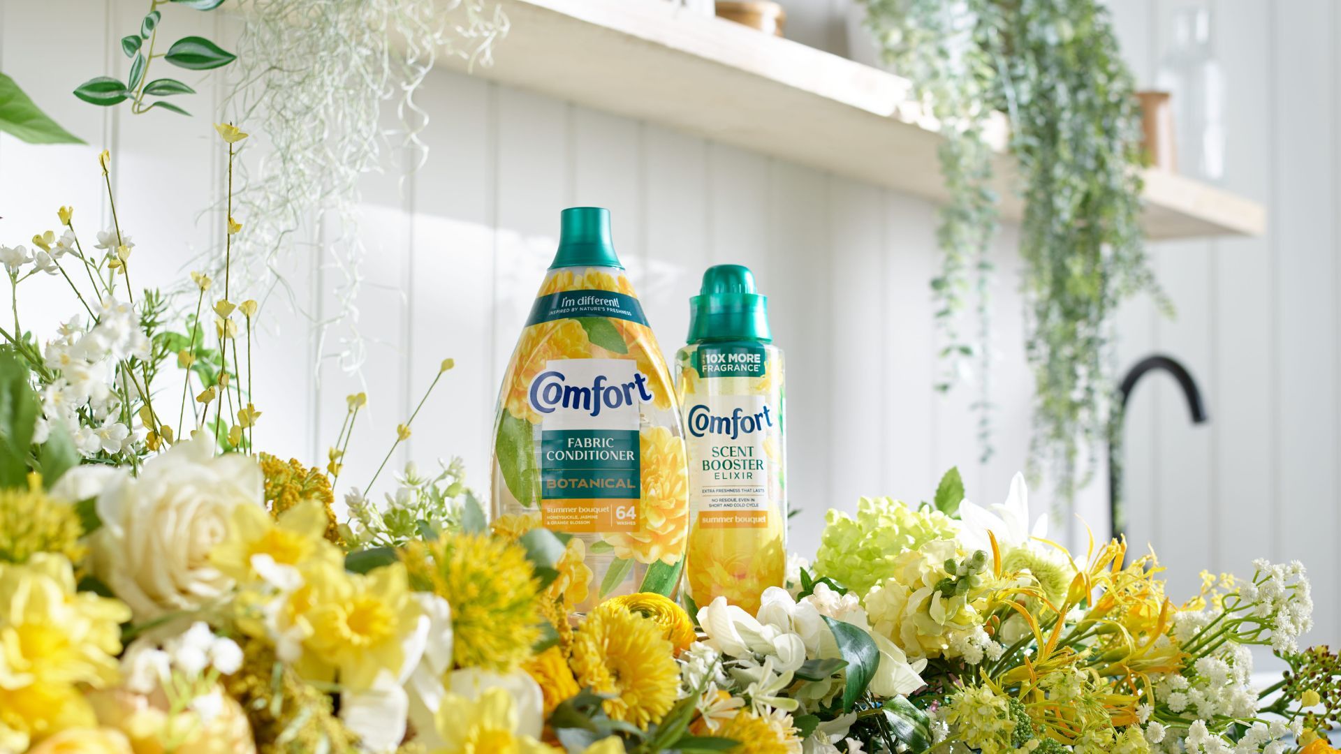 Two new Comfort innovations on a washing machine surrounded by flowers.