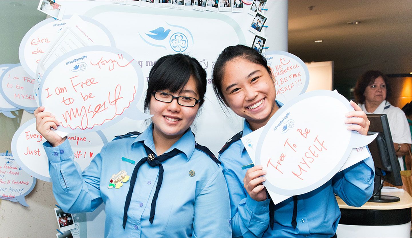 Two people holding up signs