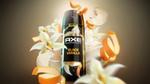 A can of Axe Black Vanilla surrounded by vanilla flowers, curls of orange zest and scoops of vanilla ice cream.